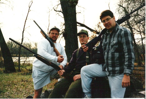 L. to R.: Dwight “D” Stever, John “E” Ellis, and Mitch “Spence” Baier posing with their shotguns at the Riverside Acres cabin.