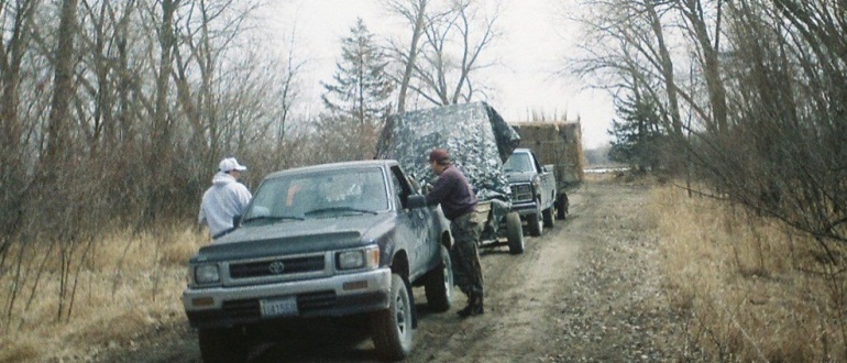 End-of-season convoy of vehicles hauling equipment, pulling the air-boat, and trailering the pontoon blinds from the KMS hunting site to the Riverside Acres cabin.