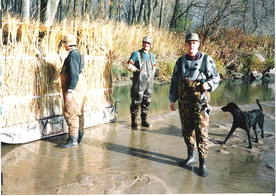 L. to R.: Mitch “Spence” Baier, Mike Baier, and John “E” Ellis sporting their chest-high waders alongside a floating pontoon blind in the extremely shallow water along the riverbank of the Platte River at the KMS hunting site.