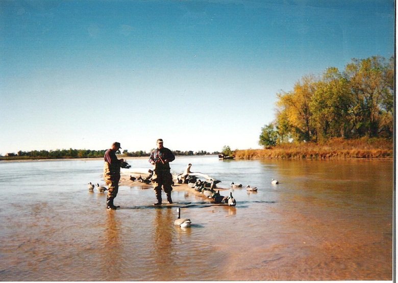 L. to R.: John “E” Ellis and George Britt “Gritt” Kirkpatrick adjusting decoys in the shallow water of the Platte River at the KMS hunting site.